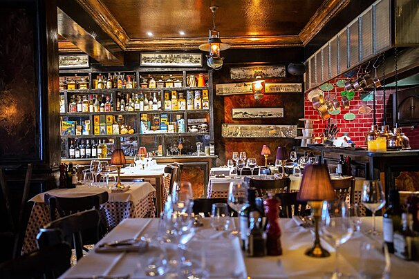 A restaurant with a lot of bottles on the shelves
