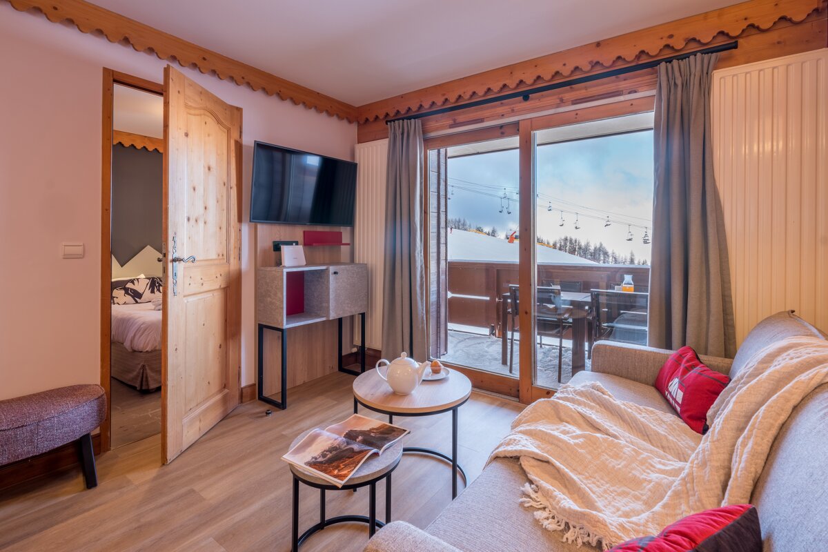 A living room with a couch and a television