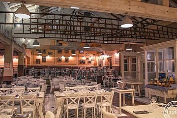 The inside of a restaurant with tables and chairs and the year 1908