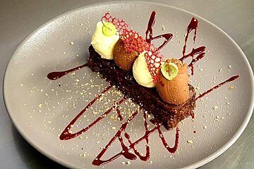 A dessert on a plate that looks like a piece of cake