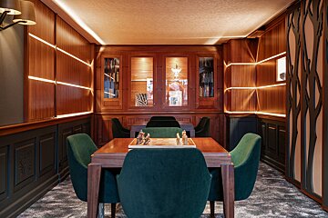 A small room with a chess board and chairs