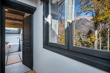A bathroom with a tub and a view of the mountains