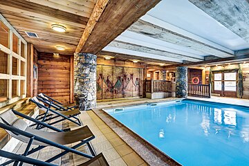 A large indoor swimming pool in a wooden building