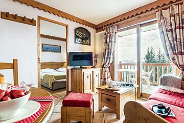 A living room with a sliding glass door leading to a balcony