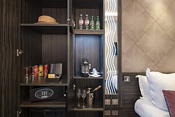 A hotel room with a coca cola can on the shelf
