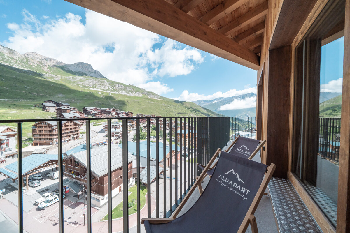 A balcony with a chair that says ' alpapart ' on it