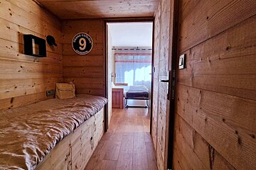 A wooden hallway with the number 9 on the wall