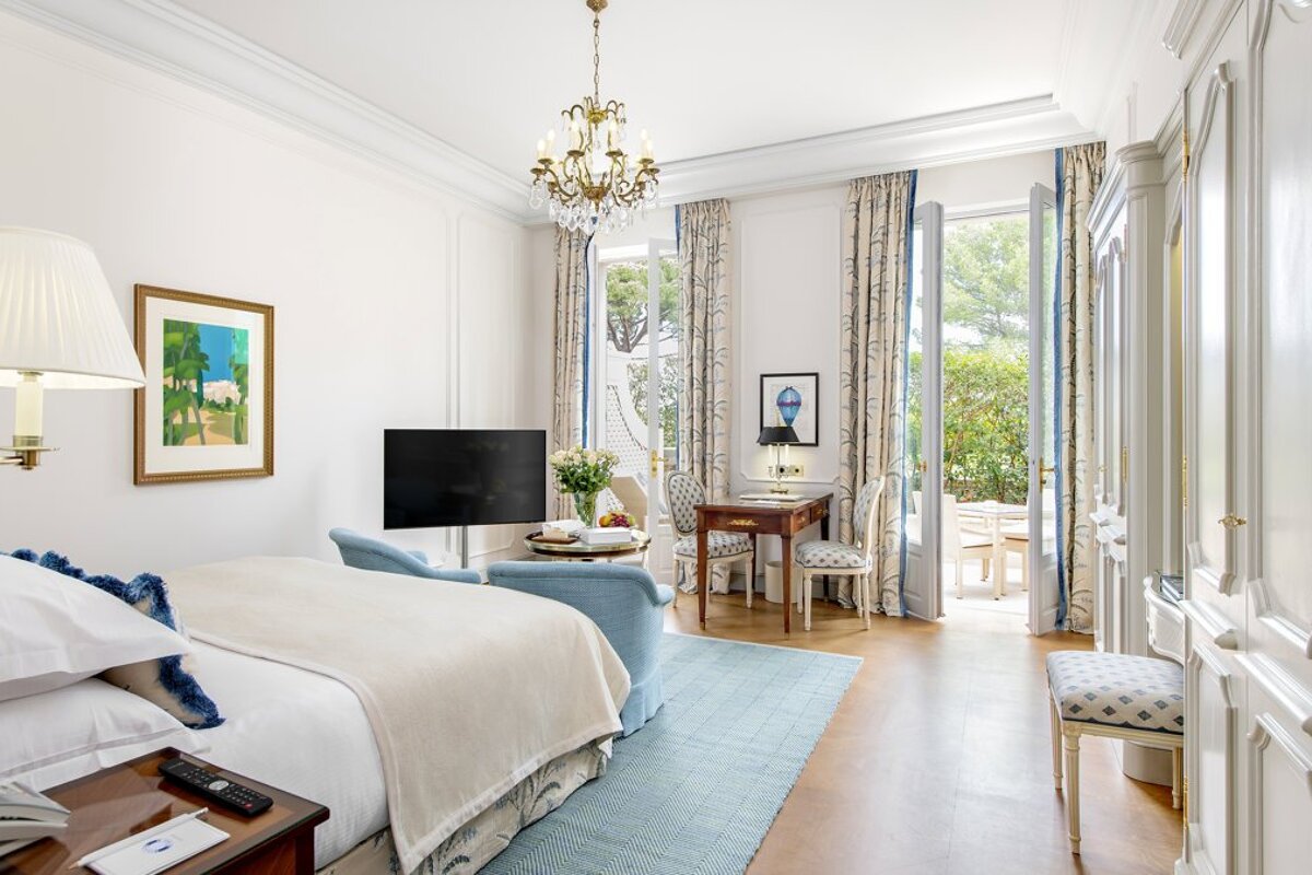 A hotel room with a large bed and a flat screen tv