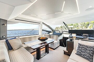 A table with a bowl of fruit on it in a living room on a boat