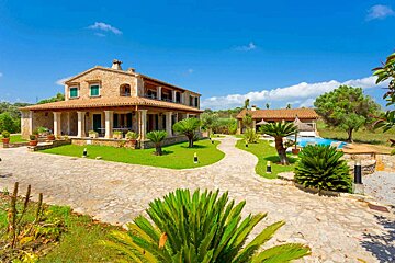 A large house with a swimming pool in the backyard