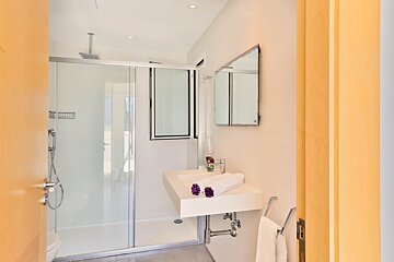 A bathroom with a sink and a walk in shower