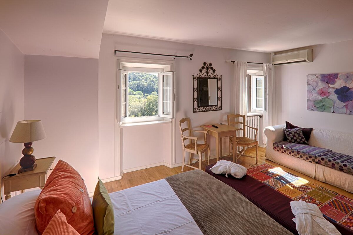 A bedroom with a couch and a table and chairs