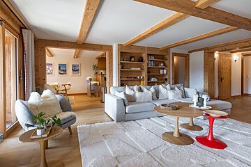 A living room with a couch and a red table
