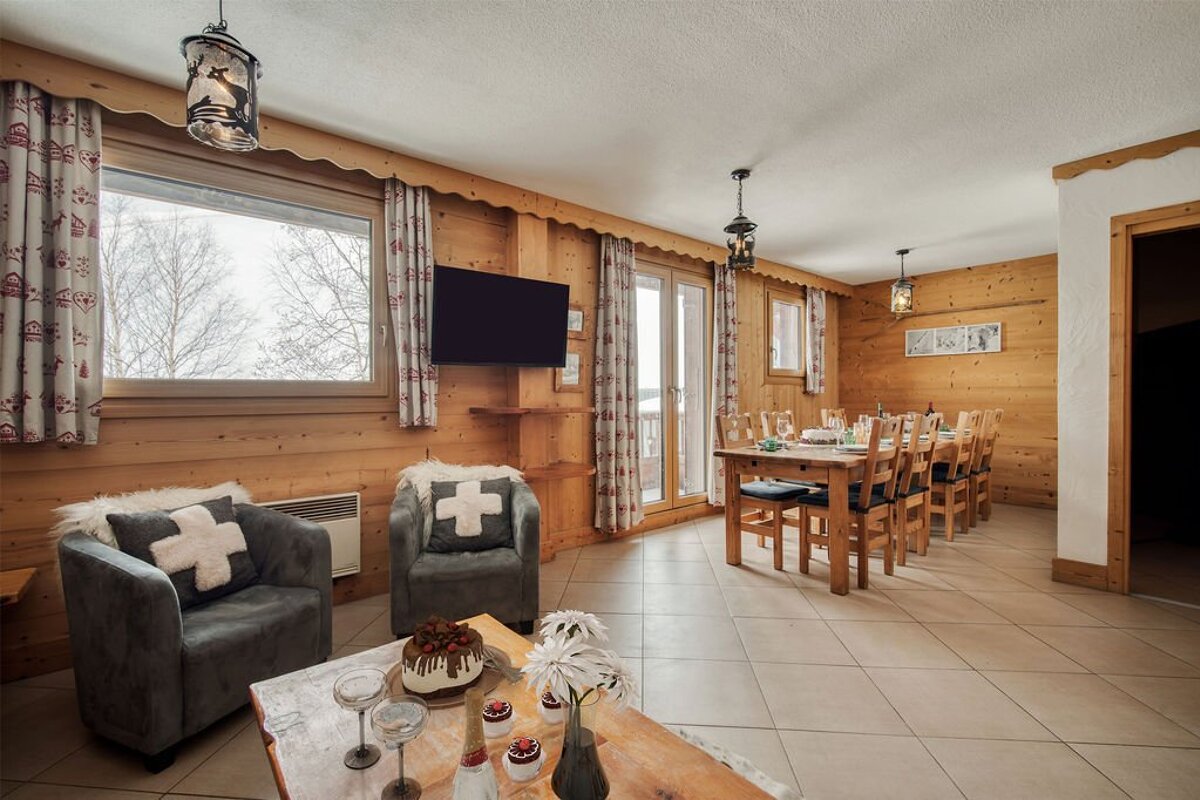 A living room with a chair with a cross on it