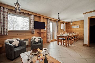 A living room with a chair with a cross on it