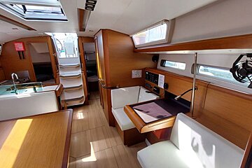 The inside of a boat with a table and chairs