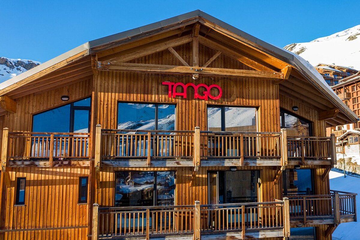A large wooden building with the word tango on it