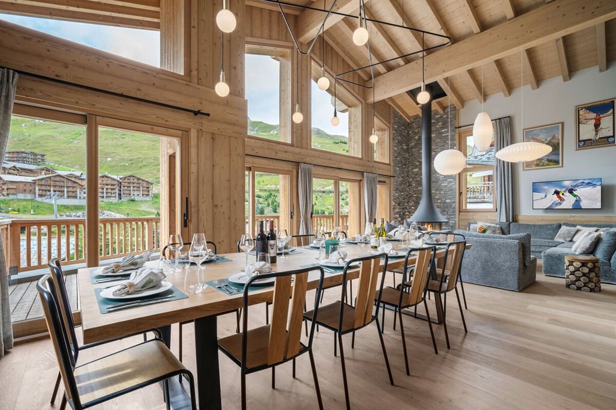 A dining room table with plates and glasses on it