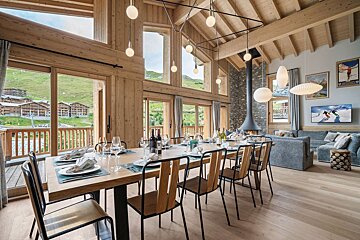 A dining room table with plates and glasses on it