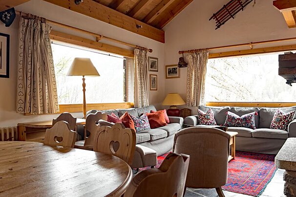 A living room with a couch and chairs and a table