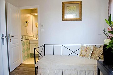 A room with a couch and a picture on the wall