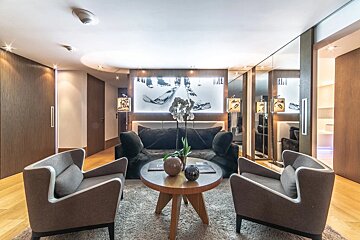 A living room with a couch and two chairs