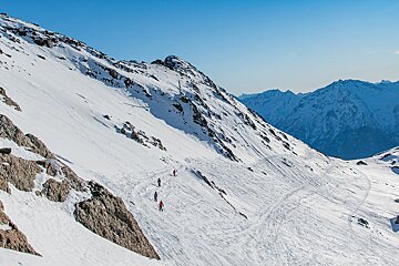 A group of people skiing down a snowy mountain