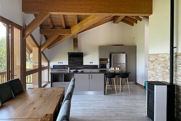 A kitchen with a stove and a table and chairs
