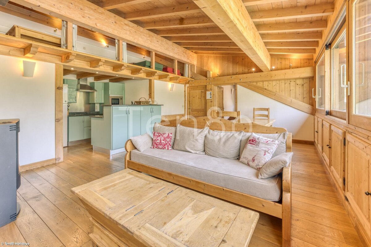 A living room with a couch and a wooden coffee table