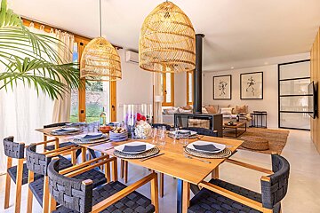 A dining room with a wooden table and black chairs