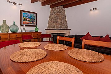 A living room with a fireplace and a painting on the wall