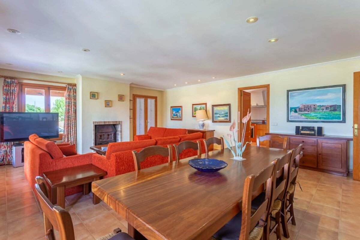A living room with a dining table and chairs