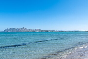A large body of water with mountains in the background