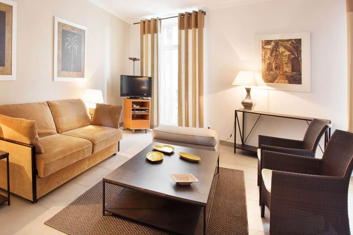 A living room with a couch and two chairs