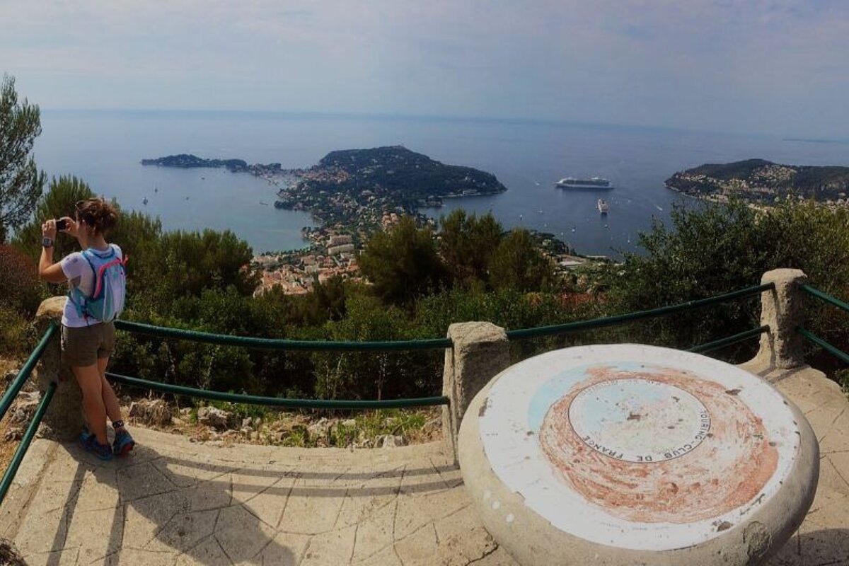 a woman taking a photo on part of a hiking trail