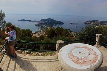 a woman taking a photo on part of a hiking trail
