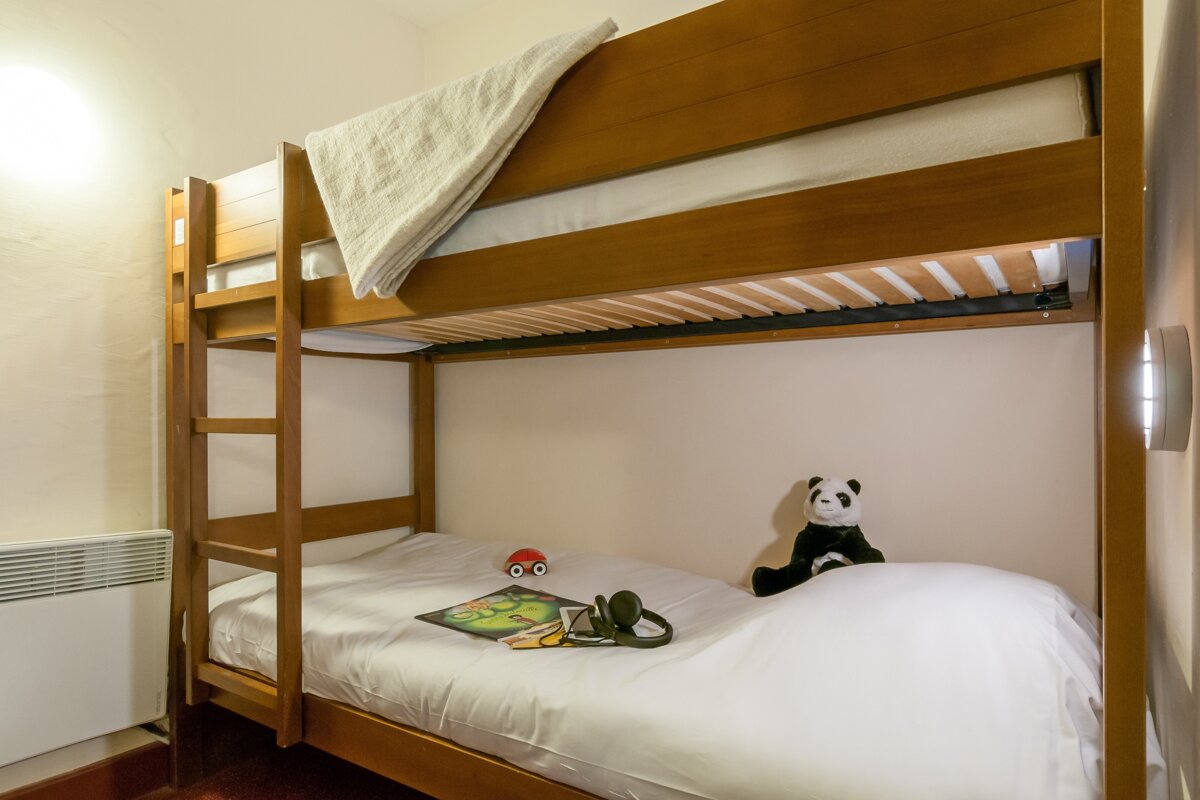 A bunk bed with a stuffed panda on it