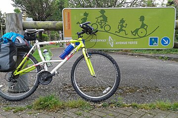 a bike resting against a cycle route sign