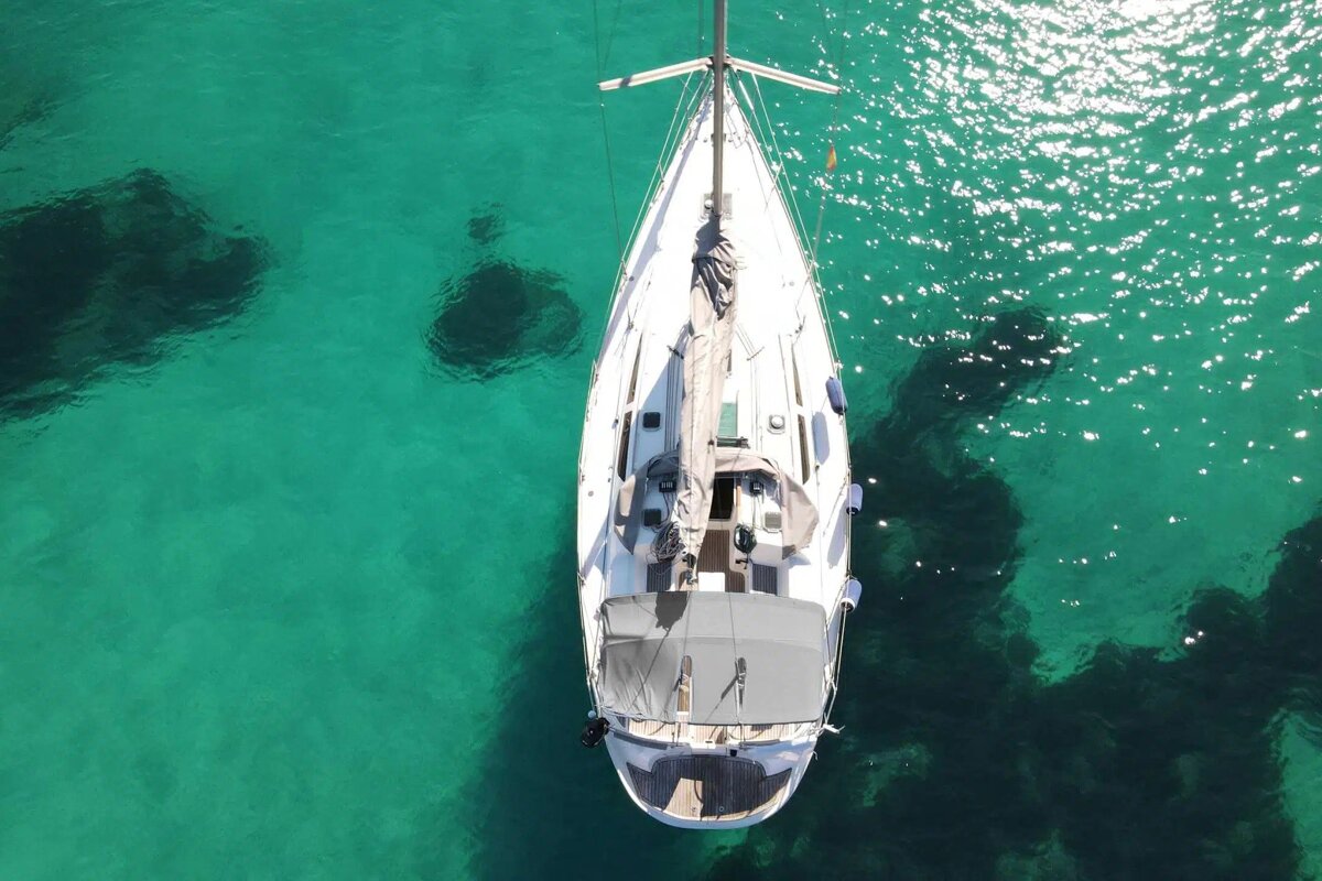 An aerial view of a sailboat in the ocean