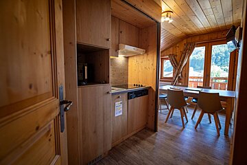 A kitchen with a sign on the door that says ' a ' on it