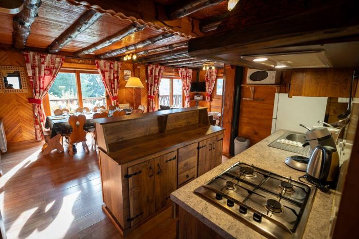 A kitchen with a stove top oven and a microwave