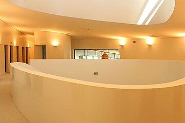 cream walls and a curved wall around a stairwell