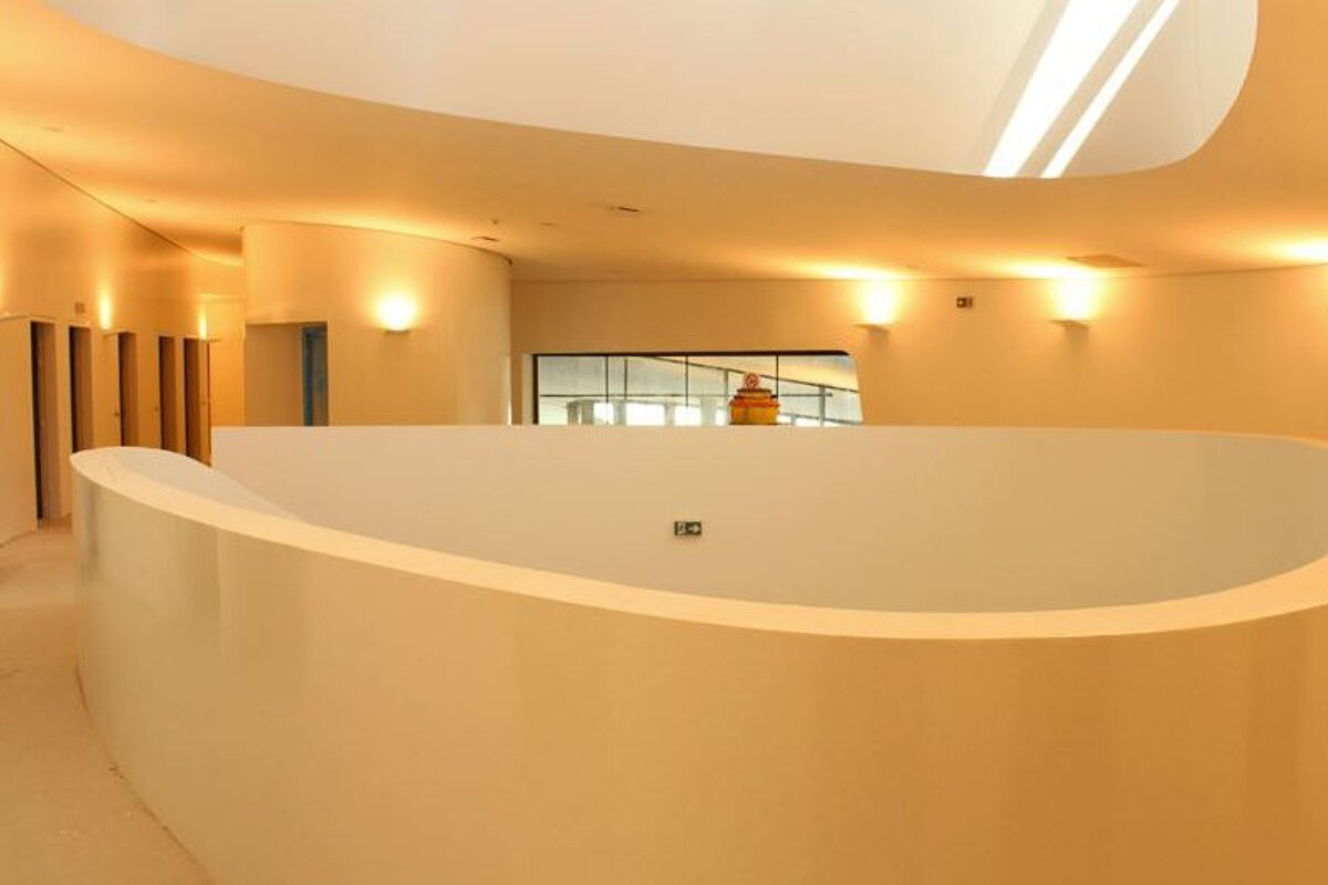 cream walls and a curved wall around a stairwell