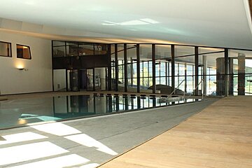 a section of wooden flooring next to a swimming pool