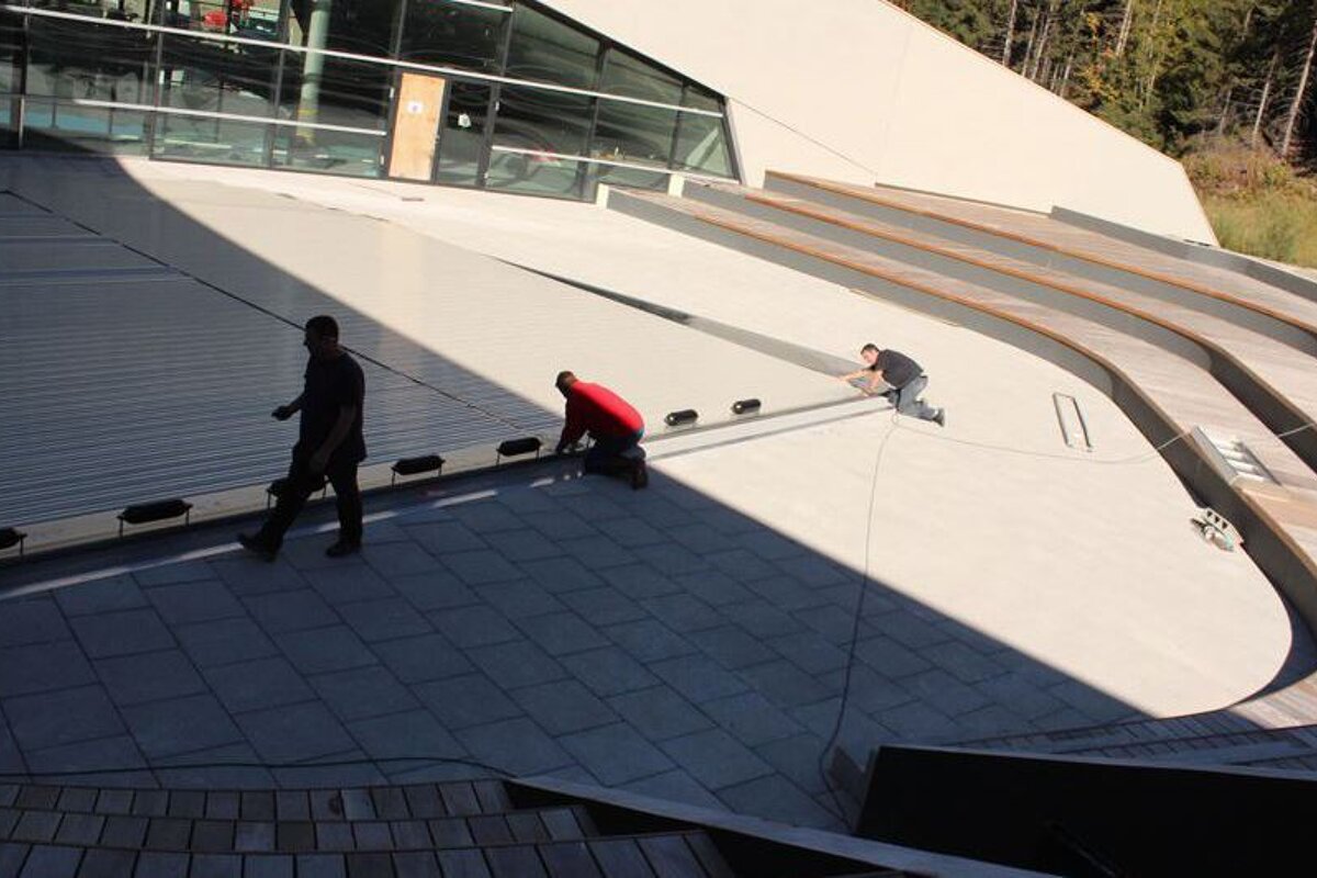 workmen in courchevel finishing off the swimming pool