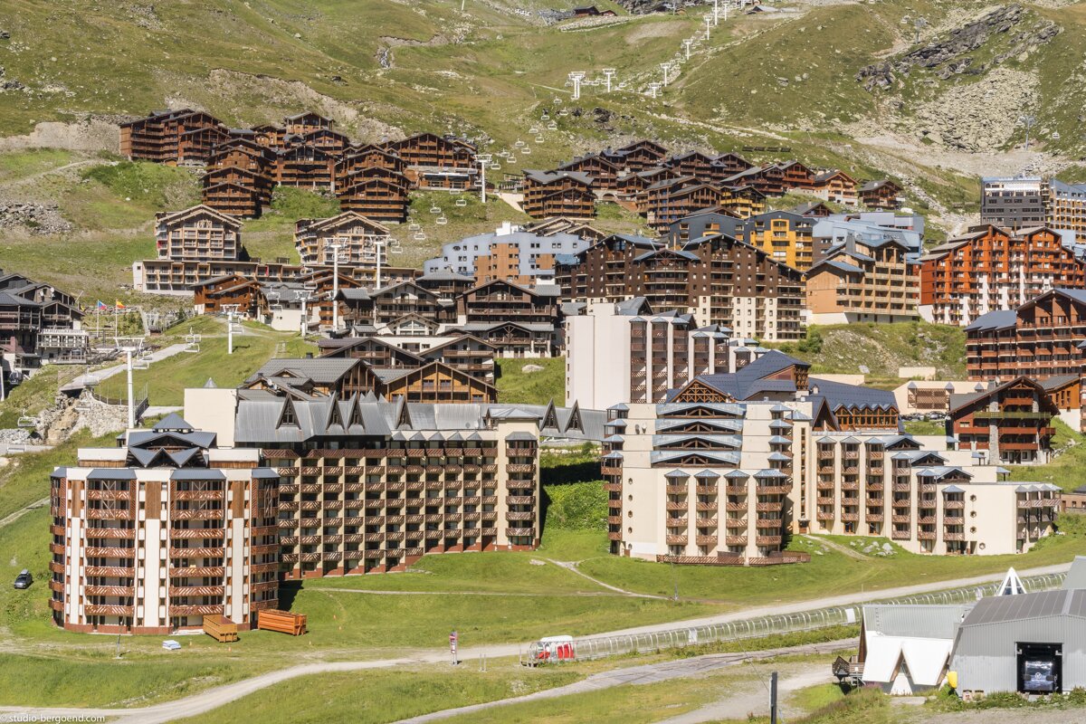 A ski resort with a lot of buildings on a hillside