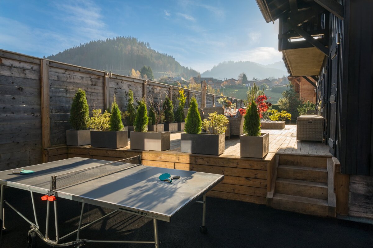 A table with ping pong balls and ping pong rackets on it