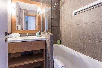 A bathroom with a bathtub and a sink