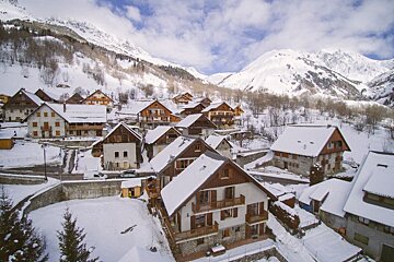 A snowy village with mountains in the background