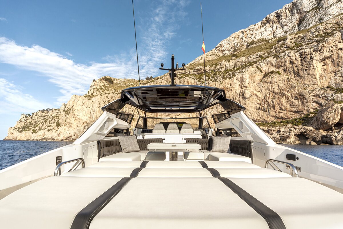 The front of a boat with a mountain in the background